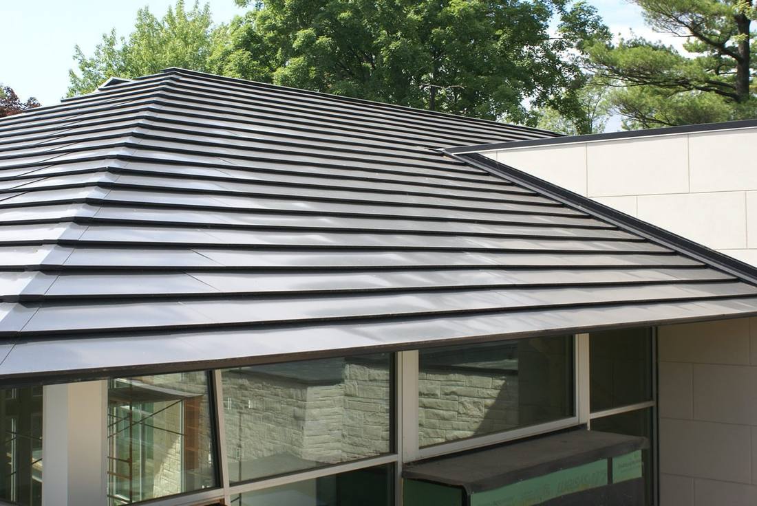 Close-up of a Luma integrated solar shingle roof, showing the metal shingle pattern with no racking or standoff hardware