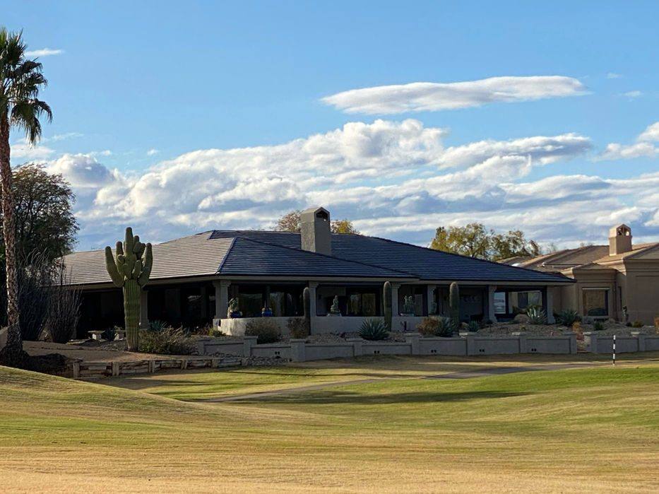 Single-story desert home with a Voltaic ICON solar tile roof, saguaro cactus and golf course fairway in the foreground
